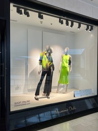 Photo of WARSAW, POLAND - JULY 13, 2022: Massimo Dutti store window display with clothes on mannequins in shopping mall