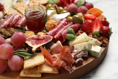Photo of Different tasty appetizers on white table, closeup