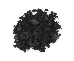 Pile of crushed activated charcoal pills on white background, top view. Potent sorbent