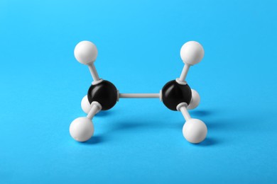 Photo of Molecule of alcohol on light blue background. Chemical model