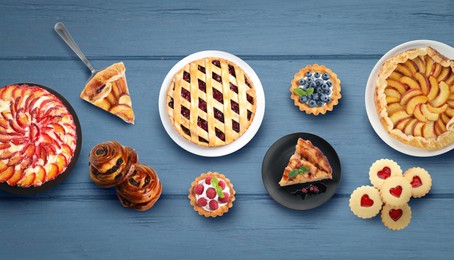 Flat lay composition with different delicious pies on blue wooden table. Banner design