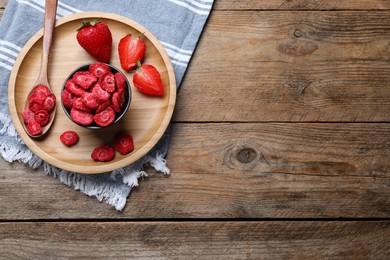 Freeze dried and fresh strawberries on wooden table, top view. Space for text