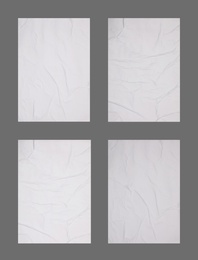Collection of creased blank posters on grey background