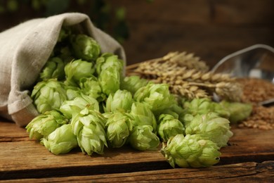Photo of Fresh green hops on wooden table, closeup