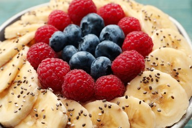 Tasty breakfast dish with berries, banana and chia seeds, closeup