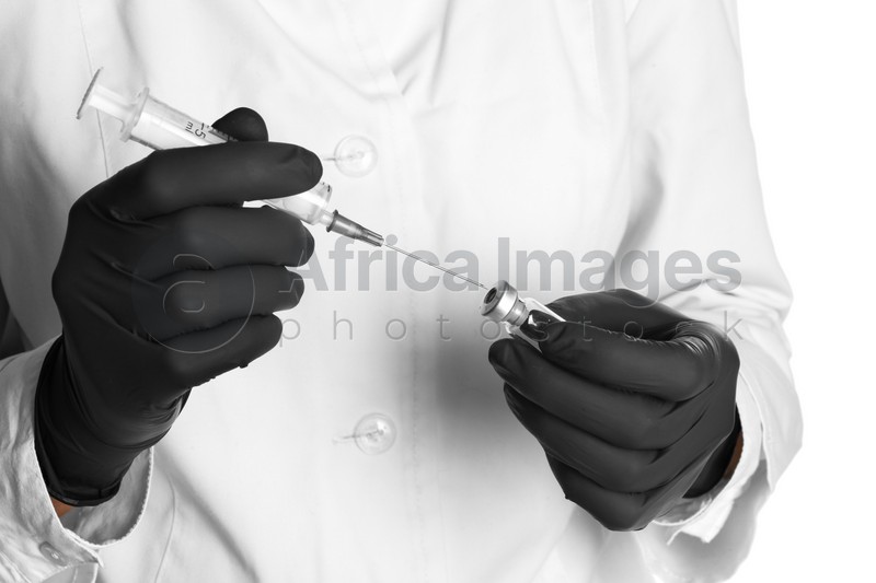 Doctor in medical gloves with syringe and vial, closeup