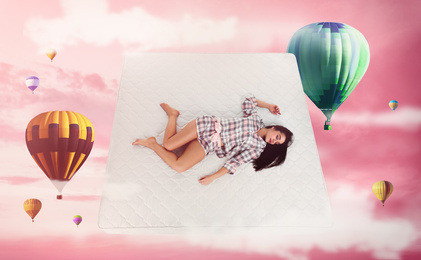Sweet dreams. Pink cloudy sky with hot air balloons around sleeping young woman 