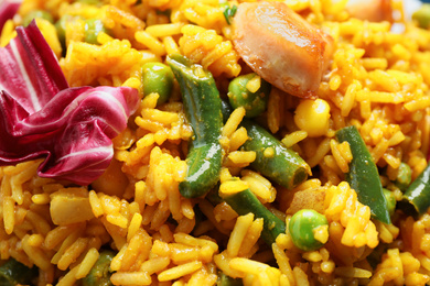 Delicious rice pilaf with chicken and vegetables as background, closeup