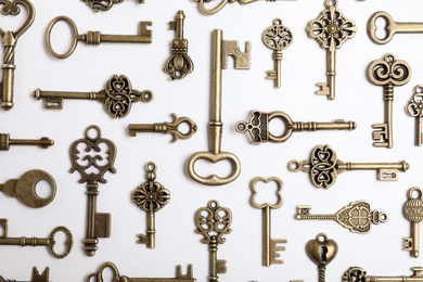 Bronze vintage ornate keys on white background, top view