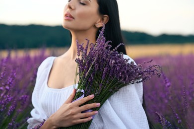 Woman with bouquet in lavender field, closeup