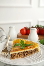 Piece of delicious pie with minced meat on table indoors