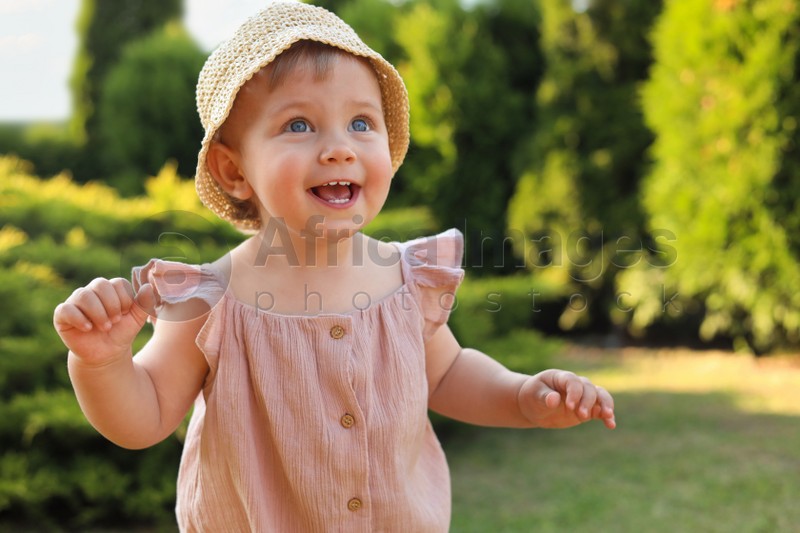 Cute little girl wearing stylish clothes outdoors on sunny day