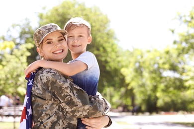 American soldier with her son outdoors. Military service
