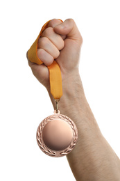 Man holding bronze medal on white background, closeup. Space for design