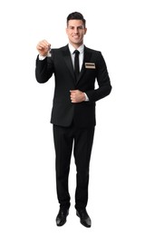 Happy receptionist in uniform holding key on white background