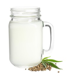Mason jar of fresh hemp milk, leaf and seeds on white background