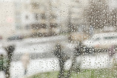 Closeup view of foggy window with rain drops