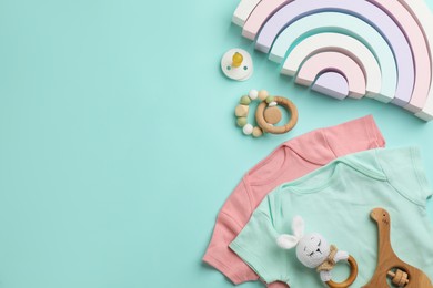 Flat lay composition with baby clothes and accessories on light blue background, space for text