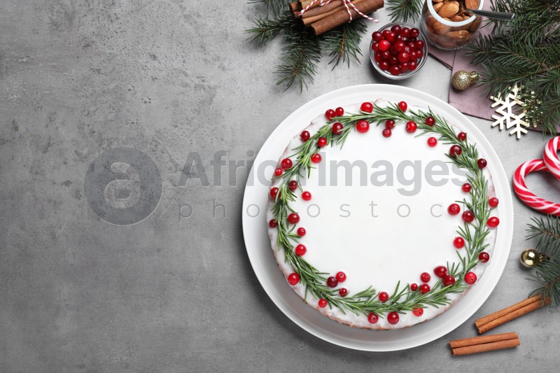Photo of Flat lay composition with traditional Christmas cake on light grey table. Space for text