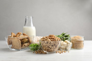 Different organic soy products on white wooden table