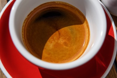 Above view of cup with aromatic hot coffee, closeup