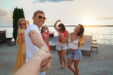 Photo of Group of happy people enjoying fun party outdoors