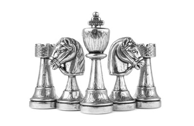 Set of silver chess pieces on white background