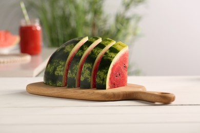 Slices of delicious ripe watermelon on white wooden table indoors