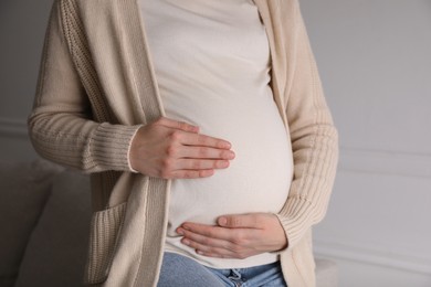 Young pregnant woman at home, closeup view