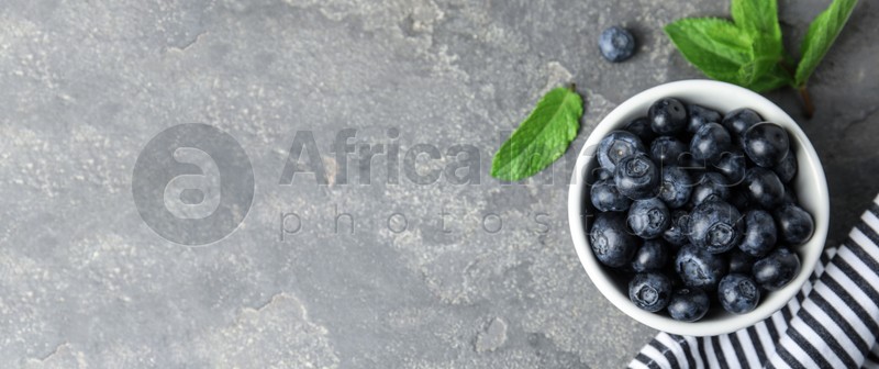 Tasty fresh blueberries on light grey table, flat lay with space for text. Banner design