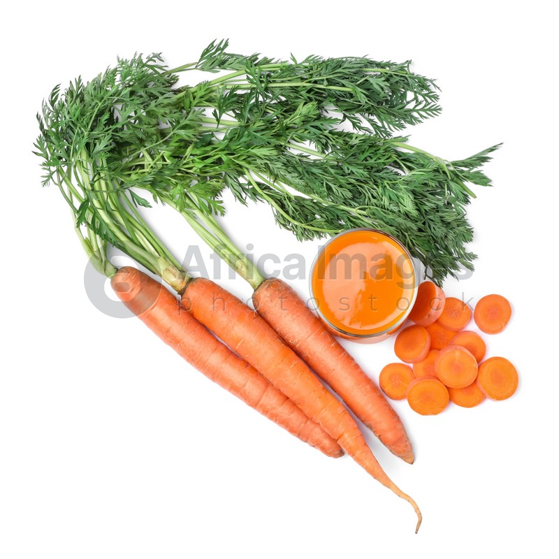 Freshly made carrot juice in glass isolated on white, top view