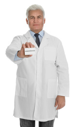 Doctor holding business card with word HEMORRHOID on white background