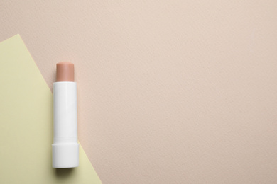 Hygienic lipstick on color background, top view. Space for text