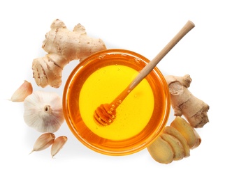 Ginger, honey and fresh garlic on white background, top view. Natural cold remedies