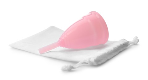 Pink menstrual cup with cotton bag on white background