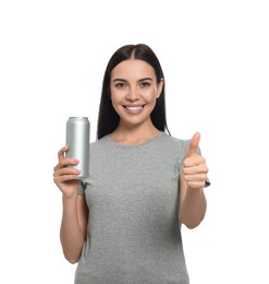 Beautiful happy woman holding beverage can and showing thumbs up on white background