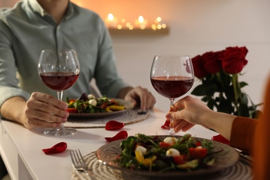 Couple having romantic dinner at home, closeup