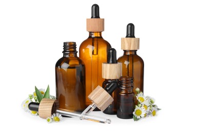 Bottles of essential oil and beautiful flowers on white background