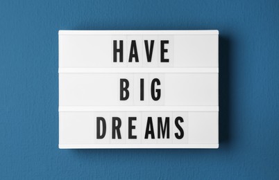 Lightbox with motivational quote Have Big Dreams on blue background, top view