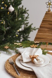 Photo of Luxury place setting with beautiful festive decor for Christmas dinner on white table
