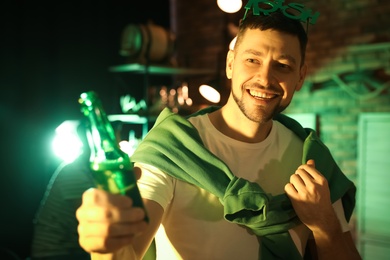 Man with beer celebrating St Patrick's day in pub