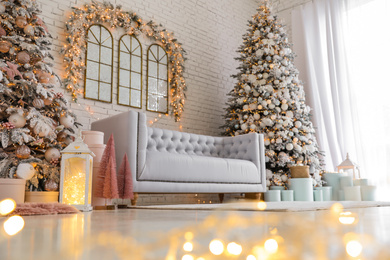 Beautiful interior of living room with decorated Christmas trees, low angle view