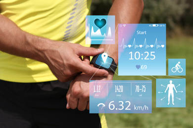 Man using smart watch during training outdoors, closeup. Illustrations near hand with device