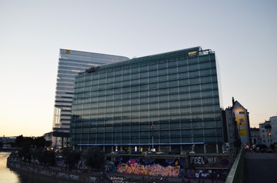 Vienna, Austria - June 20, 2018: Buildings of IBM and Raiffeisen companies near river