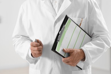 Photo of Doctor with patient's medical card in clinic, closeup