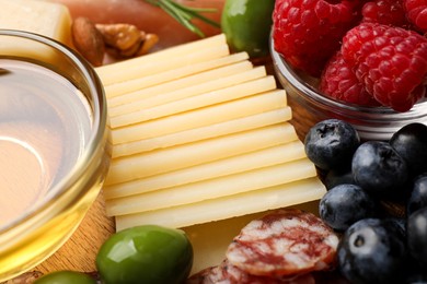 Snack set with delicious Parmesan cheese on plate, closeup