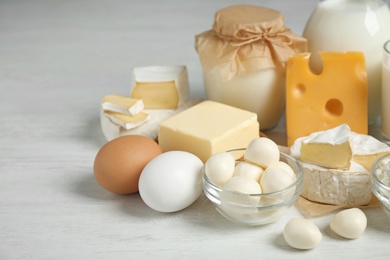 Photo of Different delicious dairy products on white table