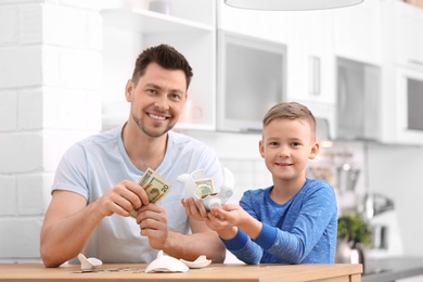 Family with broken piggy bank and money at home