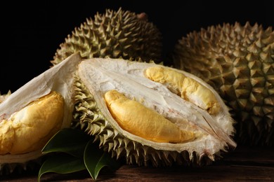 Fresh ripe durian fruits on wooden table, closeup