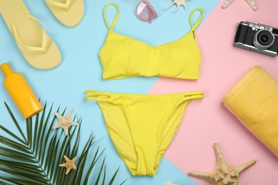 Flat lay composition with swimsuit and beach accessories on color background